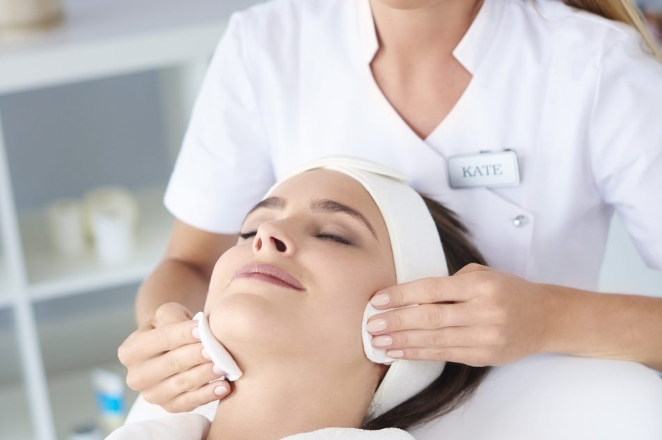 Beautiful woman doing facial her client